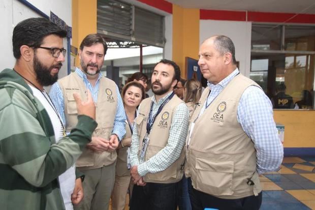El jefe de la misión electoral de la Organización de los Estados Americanos (OEA), el expresidente costarricense Luis Guillermo Solís (d), visita este domingo un colegio electoral en la zona 7 de Mixco, durante las elecciones generales, en Ciudad de Guatemala (Guatemala).