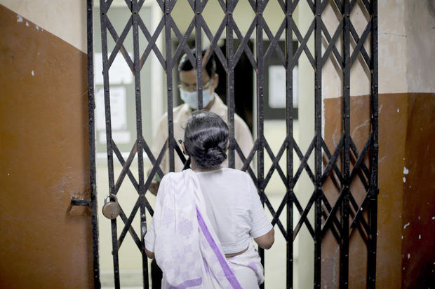 Una mujer espera para ser vacunada en un centro de Calcuta.