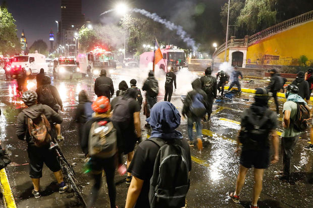 Manifestantes se enfrentan con la policía hoy en el centro de Santiago, Chile.