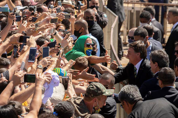 En la imagen, el presidente de Brasil, Jair Bolsonaro (d), saluda a sus simpatizantes.