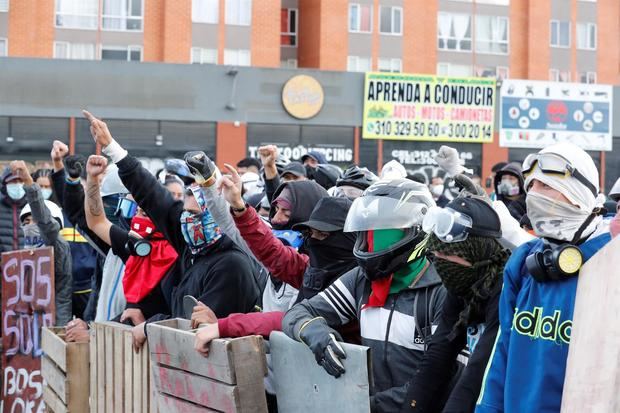 Manifestantes utilizan hoy escudos improvisados durante una protesta en el día 13 del Paro Nacional contra el Gobierno de Iván Duque, en Bogotá, Colombia.