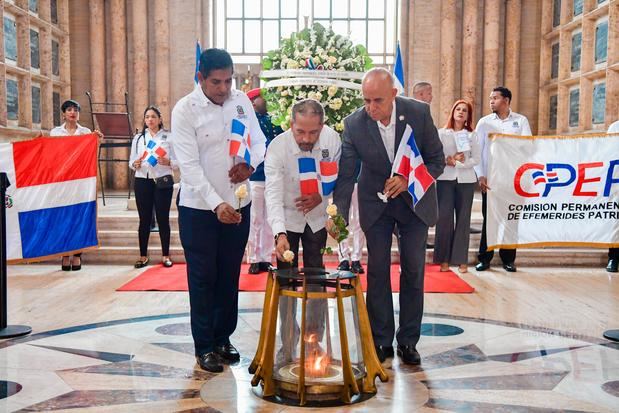 Luciano Mendoza, Juan Pablo Uribe y Luis de León, depositan una rosa en la llama votiva.